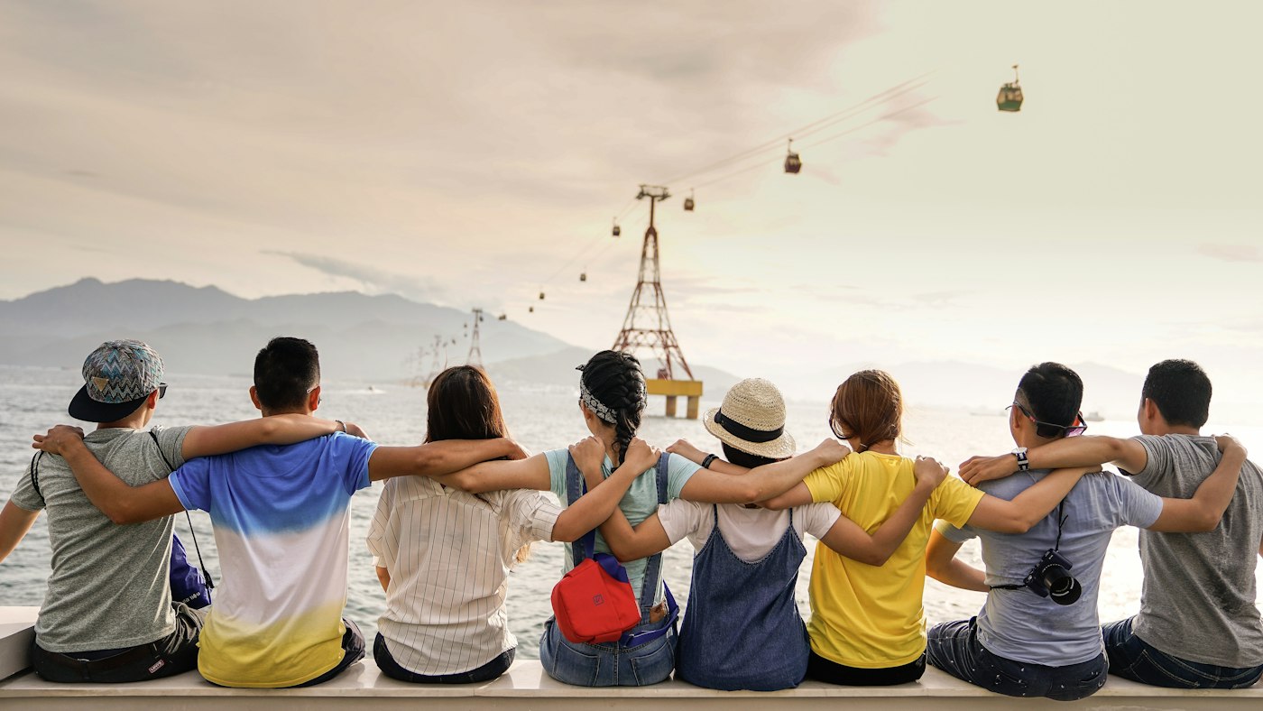 Friends sitting together, arms around each other